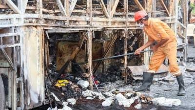 A member of the forensic team collecting samples from the spot after a bus caught fire following a collision with a two-wheeler in Kurnool on Friday. (ANI)