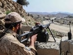 A Taliban security personnel stands guard along a road near the Ghulam Khan zero-point border crossing between Afghanistan and Pakistan in Gurbuz district in the southeast of Khost province on October 20, 2025. 