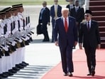 US President Donald Trump, center, speaks with Anwar Ibrahim, Malaysia's prime minister, after arriving at Kuala Lumpur International Airport in Sepang, Selangor, Malaysia, on Sunday, Oct. 26, 2025. Photographer: Samsul Said/Bloomberg(Bloomberg)