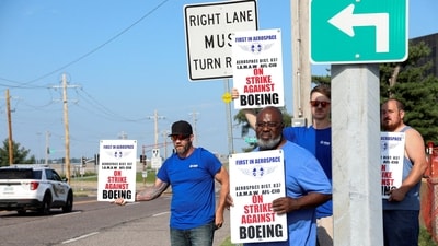 Workers hold signs during a strike over contract negotiations, outside Boeing's facility, in Missouri, U.S (REUTERS File)