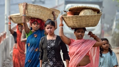 Women in Delhi carry baskets on the first day of Chhath Puja on Saturday. (ANI)