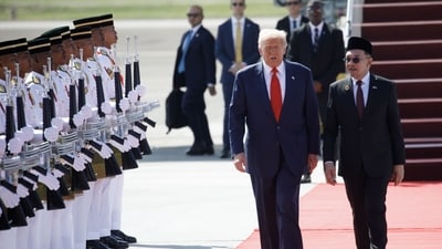 US President Donald Trump, center, speaks with Anwar Ibrahim, Malaysia's prime minister, after arriving at Kuala Lumpur International Airport in Sepang, Selangor, Malaysia, on Sunday, Oct. 26, 2025. Photographer: Samsul Said/Bloomberg (Bloomberg) US President Donald Trump, center, speaks with Anwar Ibrahim, Malaysia's prime minister, after arriving at Kuala Lumpur International Airport in Sepang, Selangor, Malaysia, on Sunday, Oct. 26, 2025. Photographer: Samsul Said/Bloomberg (Bloomberg)