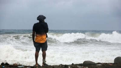 A person watches waves crash on the beach in Port Royal, Jamaica, on October 26, 2025, ahead of Hurricane Melissa's arrival. (REUTERS)