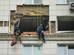 Municipal employees work at the side of a damaged multi-storey apartment building hit by a Ukrainian drone in Krasnogorsk, just outside Moscow, Municipal employees work at the side of a damaged multi-storey apartment building hit by a Ukrainian drone in Krasnogorsk, just outside Moscow,