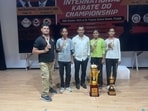 Tarun Sharma with his three students after winning four gold medals at open karate championship held in Batala on Sunday. (HT Photo)