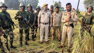 Border Security Force (BSF) and police personnel after recovering two packets containing suspected heroin, dropped by a Pakistani drone, during a joint search operation in RS Pura sector of Jammu on Monday. (PTI Photo) Border Security Force (BSF) and police personnel after recovering two packets containing suspected heroin, dropped by a Pakistani drone, during a joint search operation in RS Pura sector of Jammu on Monday. (PTI Photo)