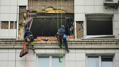 Municipal employees work at the side of a damaged multi-storey apartment building hit by a Ukrainian drone in Krasnogorsk, just outside Moscow, (AP) Municipal employees work at the side of a damaged multi-storey apartment building hit by a Ukrainian drone in Krasnogorsk, just outside Moscow, (AP)