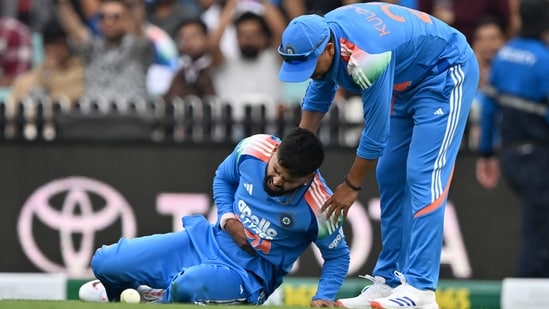 Shreyas Iyer (L) reacts in pain after falling on the ground while taking a catch to dismiss Alex Carey during the third ODI between Australia and India (AFP)