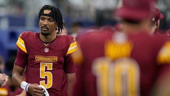 Washington Commanders quarterback Jayden Daniels walks on the sideline. (AP)