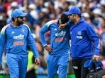 India's Shreyas Iyer (C) reacts in pain after falling on the ground while taking a catch to dismiss Australia's Alex Carey as his teammate Rohit Sharma (L) watches India's Shreyas Iyer (C) reacts in pain after falling on the ground while taking a catch to dismiss Australia's Alex Carey as his teammate Rohit Sharma (L) watches