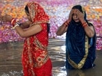 Devotees offer prayers to the rising sun on the fourth and last day of Chhath Puja, in Noida. (Sunil Ghosh/ HT Photo)