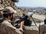 A Taliban security personnel stands guard along a road near the Ghulam Khan zero-point border crossing between Afghanistan and Pakistan in Gurbuz district in the southeast of Khost province.