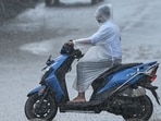 A motorist covers himself using plastic raingear as he rides along a street amid heavy rains in Chennai on October 22, 2025. A motorist covers himself using plastic raingear as he rides along a street amid heavy rains in Chennai on October 22, 2025.