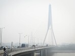 Vehicles seen on the Signature Bridge in Delhi on a polluted morning. Vehicles seen on the Signature Bridge in Delhi on a polluted morning.