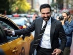 Democratic candidate for New York City Mayor, Zohran Mamdani, shakes the hand of a cab driver while campaigning in Manhattan's Upper East Side neighborhood during early voting, in New York City, on October 27, 2025. 