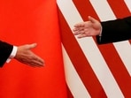 US President Donald Trump and China's President Xi Jinping shake hands