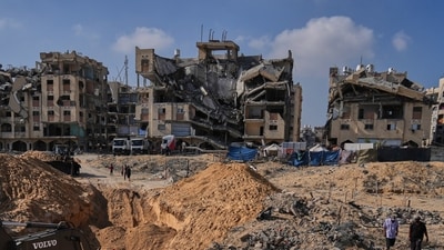 Palestinians watch as Egyptian machinery and workers search for the bodies of hostages in Hamad City, Khan Younis, in the southern Gaza Strip. (AP) Palestinians watch as Egyptian machinery and workers search for the bodies of hostages in Hamad City, Khan Younis, in the southern Gaza Strip. (AP)