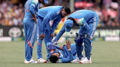 Shreyas Iyer (2R) is being checked by his teammates after he falls on the ground while taking a catch during the third ODI match vs Australia (AFP)