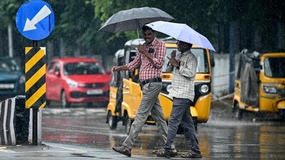 Pedestrians carry umbrellas as they walk along a street during rainfall ahead of Cyclone Montha. (AFP) Pedestrians carry umbrellas as they walk along a street during rainfall ahead of Cyclone Montha. (AFP)