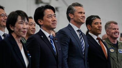 Japanese Defense Minister Shinjiro Koizumi, center left, and U.S. Defense Secretary Pete Hegseth, center right, with Japanese Prime Minister Sanae Takaichi, left, watch President Donald Trump speak to members of the military aboard the USS George Washington, an aircraft carrier docked at an American naval base, in Yokosuka, Tuesday, Oct. 28, 2025. (AP Photo/Mark Schiefelbein) (AP) Japanese Defense Minister Shinjiro Koizumi, center left, and U.S. Defense Secretary Pete Hegseth, center right, with Japanese Prime Minister Sanae Takaichi, left, watch President Donald Trump speak to members of the military aboard the USS George Washington, an aircraft carrier docked at an American naval base, in Yokosuka, Tuesday, Oct. 28, 2025. (AP Photo/Mark Schiefelbein) (AP)