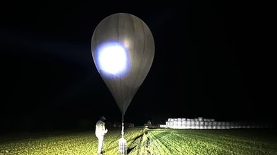 In this undated photo, an officer inspects a balloon used to carry cigarettes into Lithuania. (AP) In this undated photo, an officer inspects a balloon used to carry cigarettes into Lithuania. (AP)