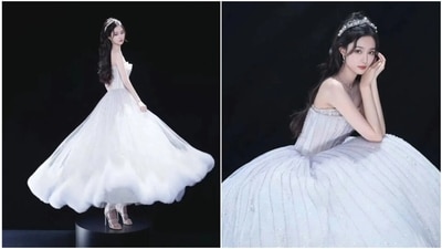 Xu Yi Yang also wore a classic princess dress with a flattering, modern neckline. This look is designed to make a bride feel regal, glamorous, and magical for wedding celebration. Xu Yi Yang also wore a classic princess dress with a flattering, modern neckline. This look is designed to make a bride feel regal, glamorous, and magical for wedding celebration.