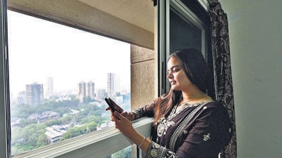 Mumbai, India - Oct. 18, 2025:Fiza Shaikh looks through window at newly alloted flats to Worli BDD chawl rsident, at worli in Mumbai, India, on Saturday, October 18, 2025. (Photo by Anshuman Poyrekar/Hindustan Times) (Anshuman Poyrekar/HT Photo)