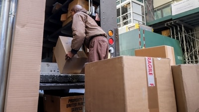 A UPS worker unloads packages from a truck in New York, US. (Bloomberg) A UPS worker unloads packages from a truck in New York, US. (Bloomberg)