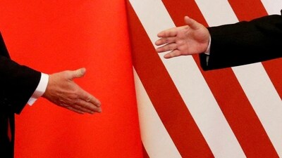 US President Donald Trump and China's President Xi Jinping shake hands (REUTERS)