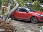 A vehicle stuck under a tree following heavy rainfall and gusty winds amid Cyclone Montha in Visakhapatnam on Tuesday.