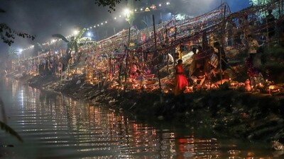 Gram it: Devotees perform early morning rituals, on Tuesday, during Chhath Puja festivities in the Capital. (Photo: ANI )