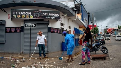 People clean a street ahead of the arrival of Hurricane Melissa in Barahona, Dominican Republic on October 28, 2025. (Photo by Carlos FABAL / AFP) (AFP) People clean a street ahead of the arrival of Hurricane Melissa in Barahona, Dominican Republic on October 28, 2025. (Photo by Carlos FABAL / AFP) (AFP)