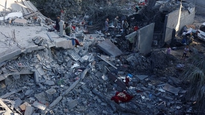Palestinians inspect the site of an overnight Israeli strike on a house, in Nuseirat, central Gaza Strip, October 29 (REUTERS)