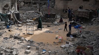 Palestinians inspect the damage at a site hit by an Israeli bombardment on Khan Younis, Gaza Strip on Wednesday. (AP)