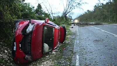 A damaged car by a fallen tree is seen after the passage of Hurricane Melissa in Manchester, Jamaica, on October 29, 2025. Hurricane Melissa ripped up trees and knocked out power after making landfall in Jamaica on October 28, 2025 as one of the most powerful hurricanes on record, inundating the island nation with rains that threaten flash floods and landslides. (Photo by Ricardo Makyn / AFP) (AFP) A damaged car by a fallen tree is seen after the passage of Hurricane Melissa in Manchester, Jamaica, on October 29, 2025. Hurricane Melissa ripped up trees and knocked out power after making landfall in Jamaica on October 28, 2025 as one of the most powerful hurricanes on record, inundating the island nation with rains that threaten flash floods and landslides. (Photo by Ricardo Makyn / AFP) (AFP)