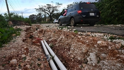 Hurricane Melissa ripped up trees and knocked out power after making landfall in Jamaica on October 28, 2025 as one of the most powerful hurricanes on record, inundating the island nation with rains that threaten flash floods and landslides. Road infrastructure is seen damaged on Spur Tree Hill main road following the passage of Hurricane Melissa in Manchester, Jamaica, on October 28, 2025. (Photo by Ricardo Makyn / AFP) (AFP) Hurricane Melissa ripped up trees and knocked out power after making landfall in Jamaica on October 28, 2025 as one of the most powerful hurricanes on record, inundating the island nation with rains that threaten flash floods and landslides. Road infrastructure is seen damaged on Spur Tree Hill main road following the passage of Hurricane Melissa in Manchester, Jamaica, on October 28, 2025. (Photo by Ricardo Makyn / AFP) (AFP)