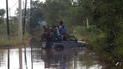 People sit on the roof of a vehicle riding on a flooded road, after Hurricane Melissa made landfall, in Prospect, Manchester, Jamaica, October 29, 2025. REUTERS/Octavio Jones (REUTERS)
