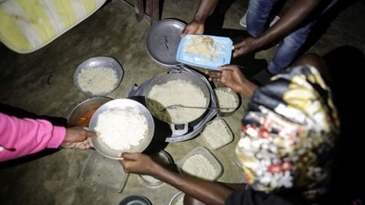 People receive food at a school turned shelter while Haiti is seeing downpours from the outer bands of Hurricane Melissa, as the storm is churning towards Cuba, after making landfall in Jamaica, in Les Cayes, Haiti, October 28, 2025. REUTERS/Patrice Noel (REUTERS)