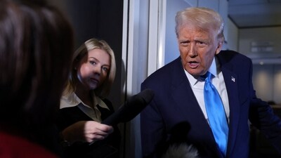 U.S. President Donald Trump speaks to members of the media next to White House Press Secretary Karoline Leavitt on board Air Force One en route to South Korea. (Reuters)