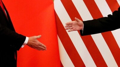 US President Donald Trump and China's President Xi Jinping shake hands at an earlier meeting. (REUTERS)