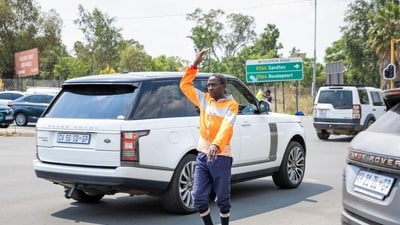 Cedric Mnisi directing traffic in a busy intersection where the lights don’t always work. Cedric Mnisi directing traffic in a busy intersection where the lights don’t always work.