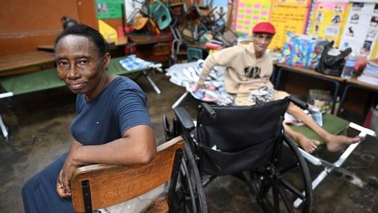 Alice Rose, 67, and her common law husband Vernon Bourne, 72, sit in a shelter at the Holy Family Primary School in Kingston on October 27, 2025. Hurricane Melissa threatened Jamaica with potentially deadly rains after rapidly intensifying into a top-level Category 5 storm, as residents scrambled for shelter from what could be the island's most violent weather on record. Melissa has already been blamed for at least four deaths in Haiti and the Dominican Republic, and was set to unleash torrential rains on parts of Jamaica in a direct hit on the Caribbean island. (Photo by Ricardo Makyn / AFP)(AFP)