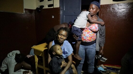 People gather at a school turned shelter while Haiti is seeing downpours from the outer bands of Hurricane Melissa, as the storm is churning towards Cuba, after making landfall in Jamaica, in Les Cayes, Haiti, October 28, 2025. REUTERS/Patrice Noel(REUTERS)