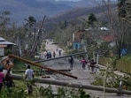 Residents walk through Lacovia Tombstone, Jamaica, in the aftermath of Hurricane Melissa.