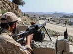A Taliban security personnel stands guard along a road near the Ghulam Khan zero-point border crossing between Afghanistan and Pakistan in Gurbuz district.