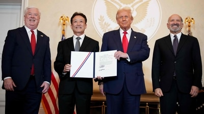 US President Donald Trump and Secretary of Commerce Howard Lutnick pose for photos after the signing of memorandums of understanding during a meeting with business leaders. (AFP) US President Donald Trump and Secretary of Commerce Howard Lutnick pose for photos after the signing of memorandums of understanding during a meeting with business leaders. (AFP)