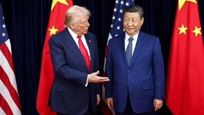 Donald Trump and Chinese President Xi Jinping talk as they hold a bilateral meeting at Gimhae International Airport (REUTERS)