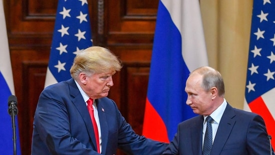 US President Donald Trump (L) and Russia's President Vladimir Putin shake hands before attending a joint press conference. (File image) (AFP)