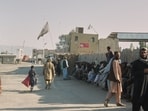 People wait near the closed gate at the Spin Boldak border crossing with Pakistan, after the border was shut for nearly two weeks following clashes between Afghan and Pakistani forces.