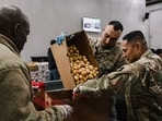 Members of the California National Guard sort donated food items at Los Angeles Regional Food Bank's South Los Angeles warehouse 